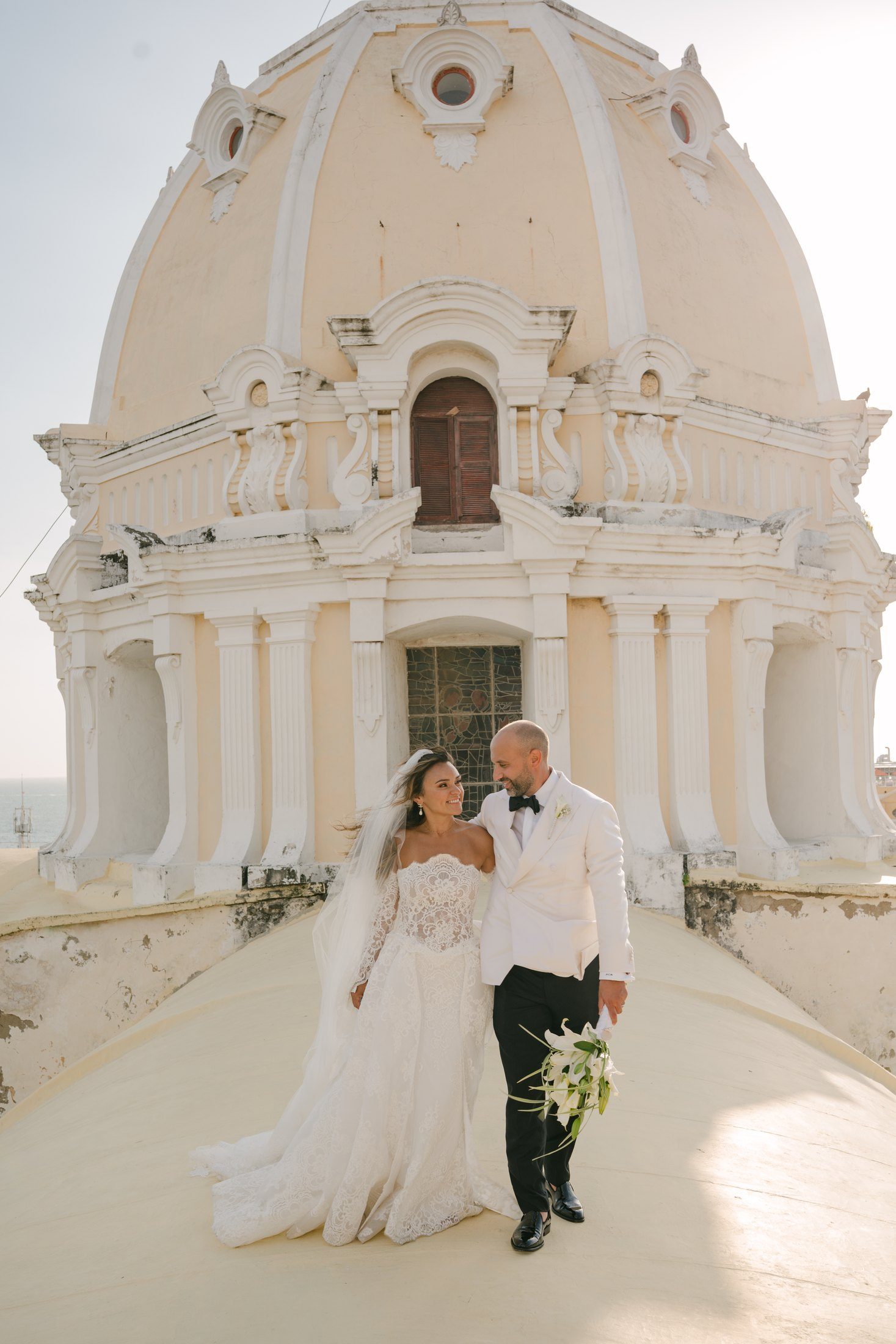 Couple walking on the rooftop beside the dome of San Pedro Claver church, Cartagena