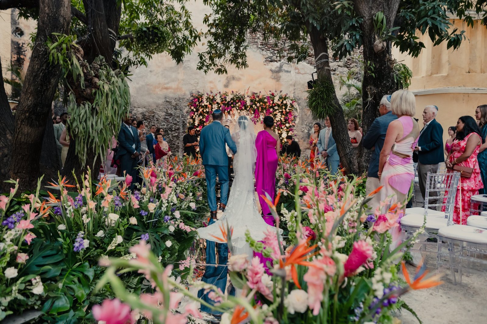 Garden ceremony with tropical flower arrangements and guests