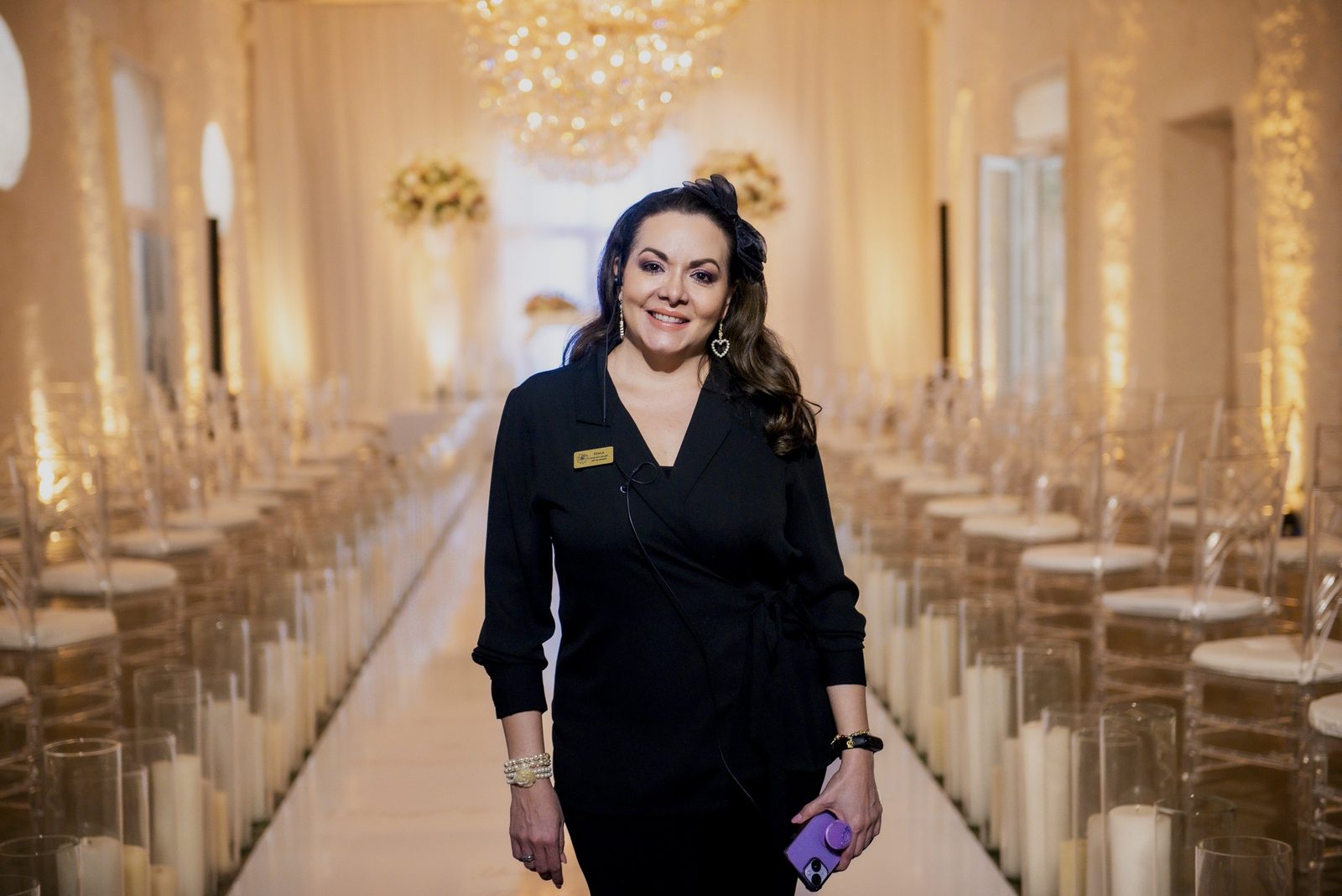 Itala Vásquez walking down a candlelit aisle