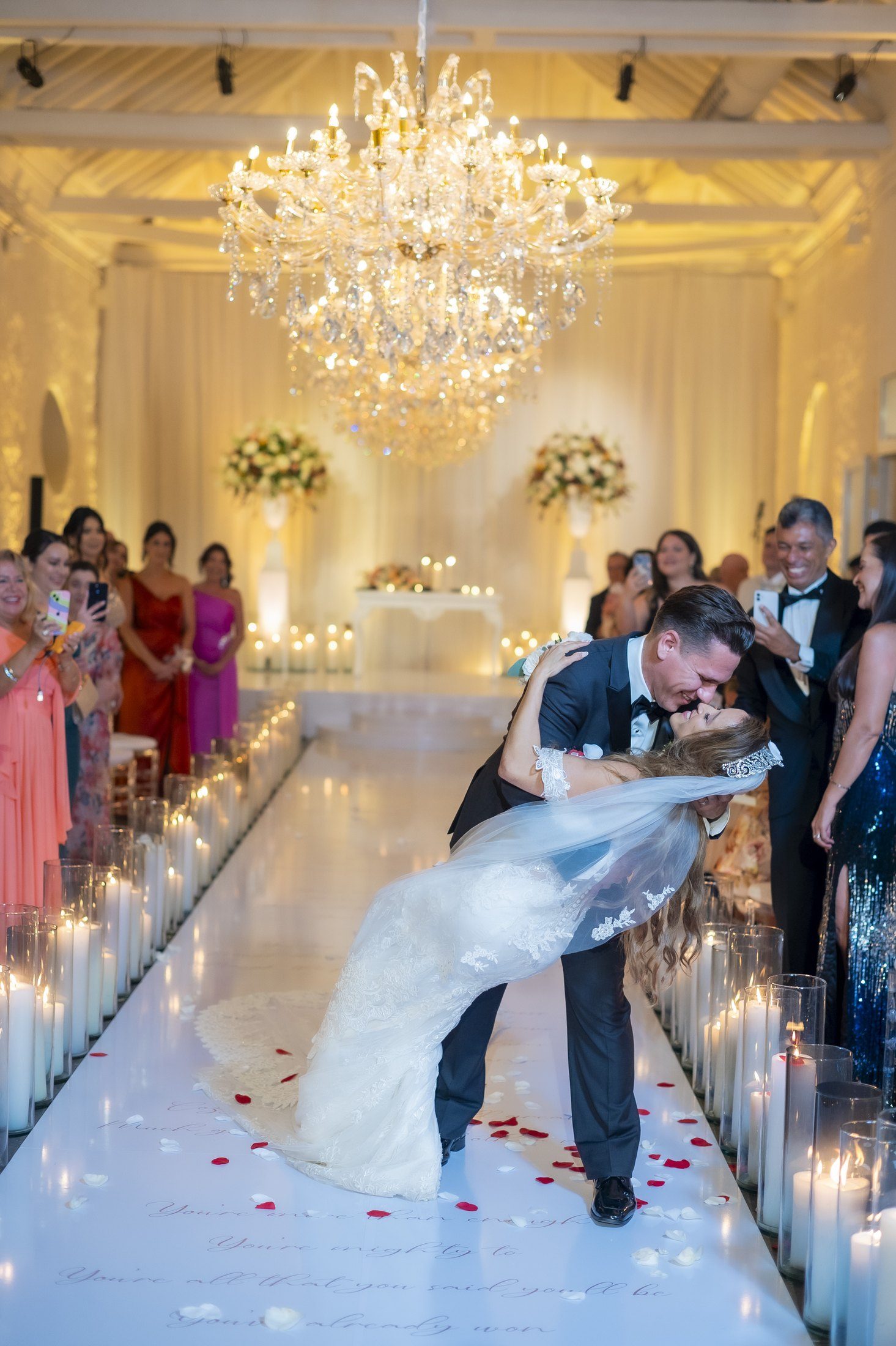 Ceremony on a mirrored aisle lined with candles