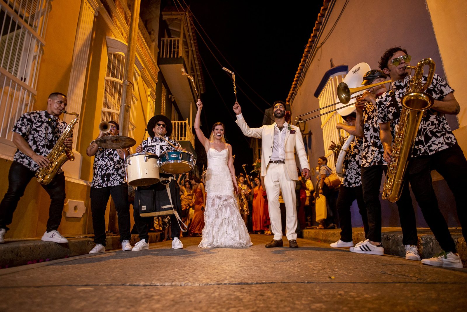 Newlyweds celebrating in the street with a brass band in Cartagena